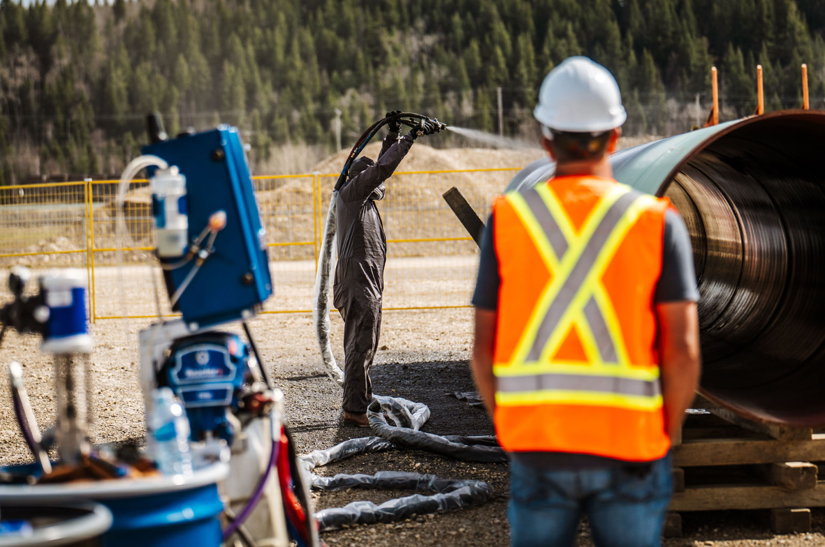 OgreKote spray application process on buried pipeline section